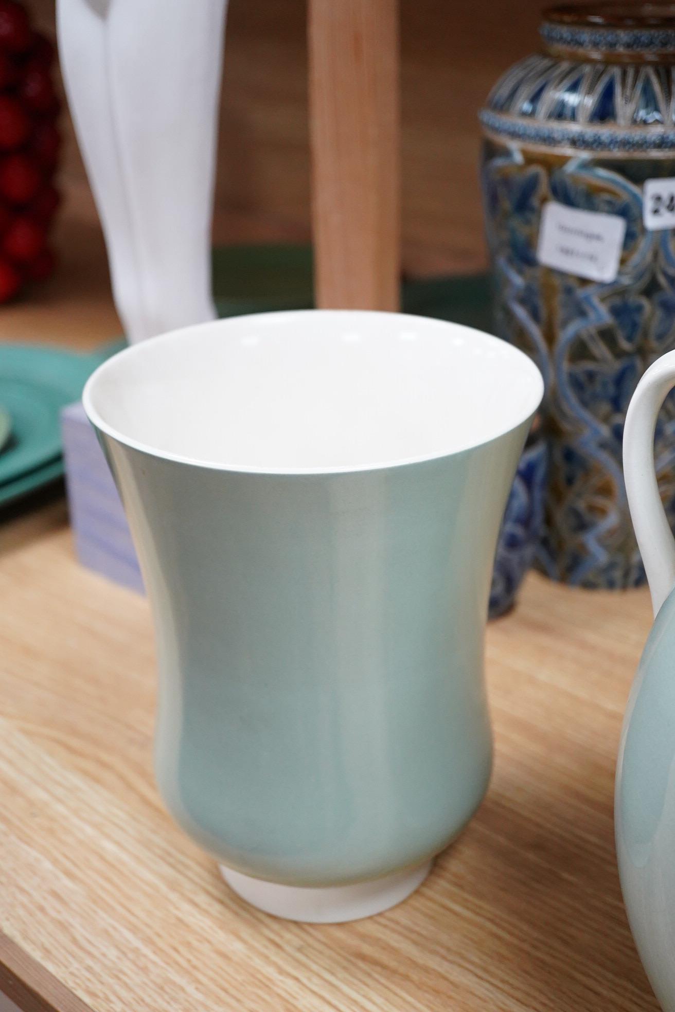 Keith Murray for Wedgwood, three celadon slipware vases, one with twin handles, largest 27cm high